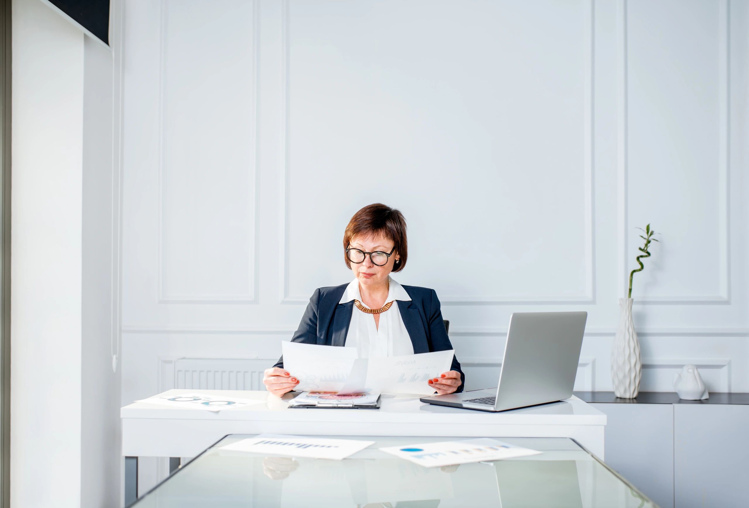 Business professional reviewing financial documents at a desk